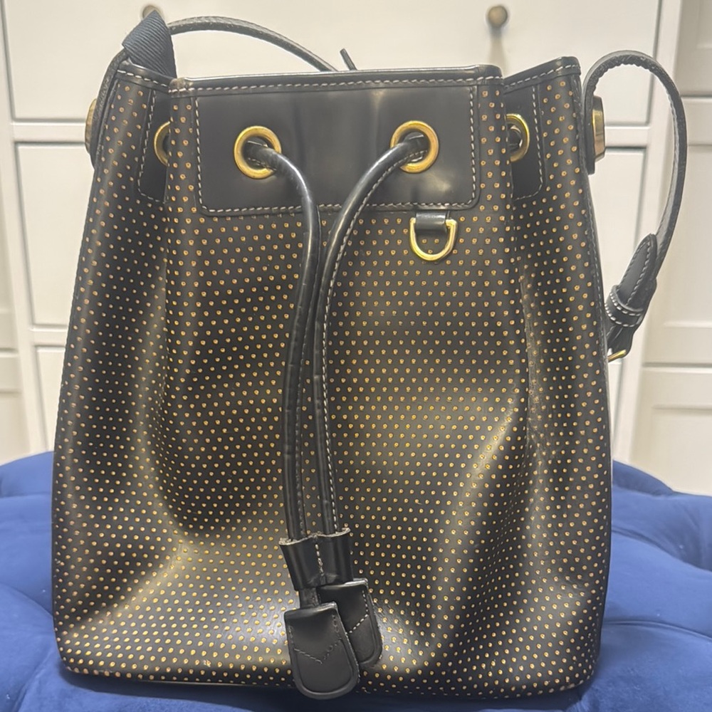 Dooney & Bourke Black and Gold Bucket Bag with Perforated Design